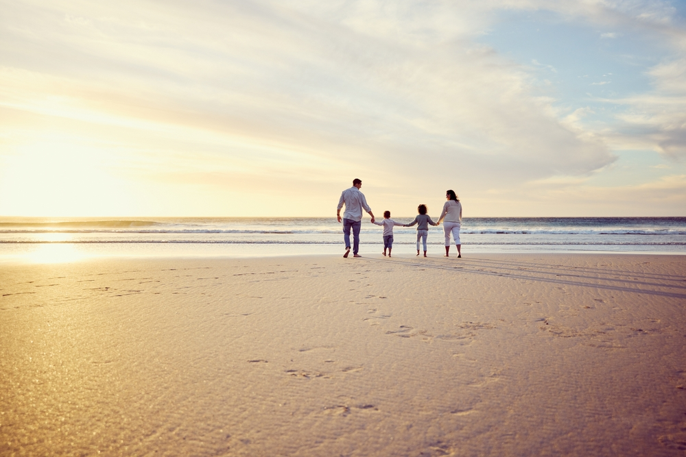 family on the beach at sunset