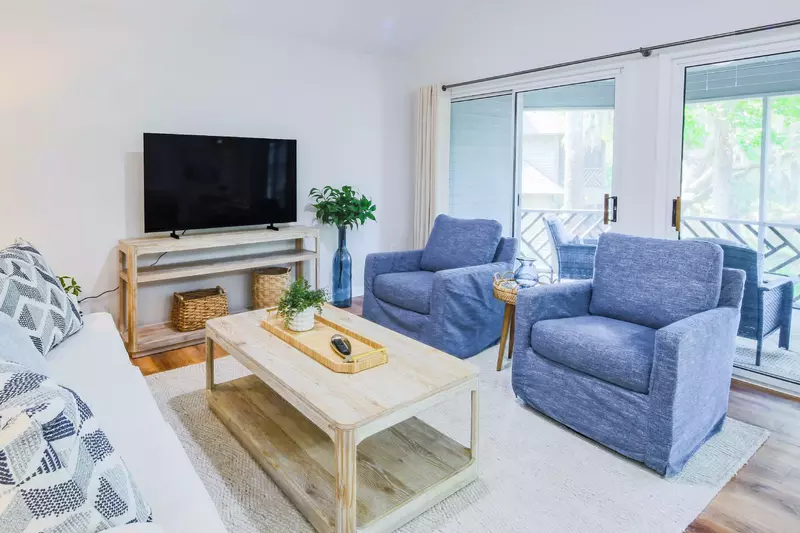 The screened porch is accessible from the living room through two sliding glass doors.
