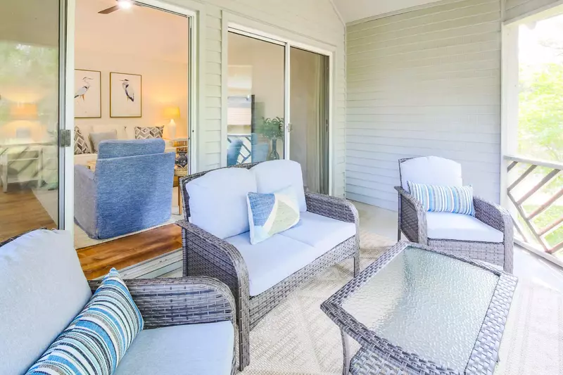 The screened porch features a comfortable seating area.