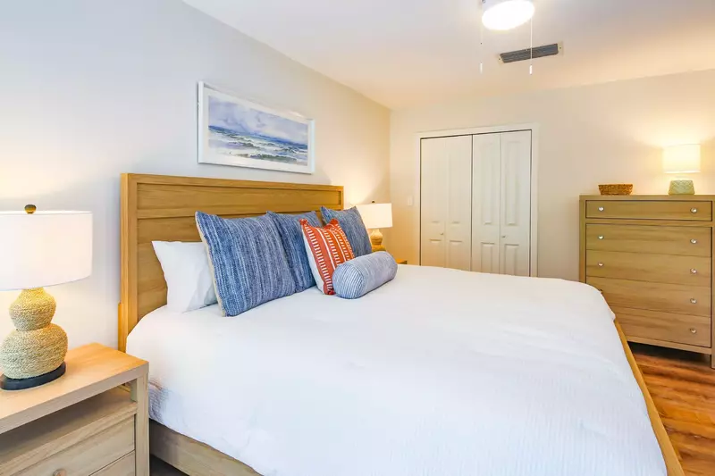 The bedroom also features a closet and dresser.