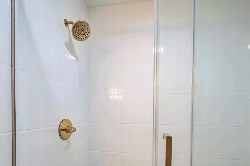 The bathroom also features a tiled, walk-in shower.