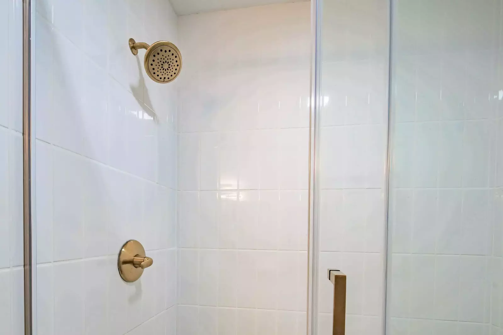 The bathroom also features a tiled, walk-in shower.