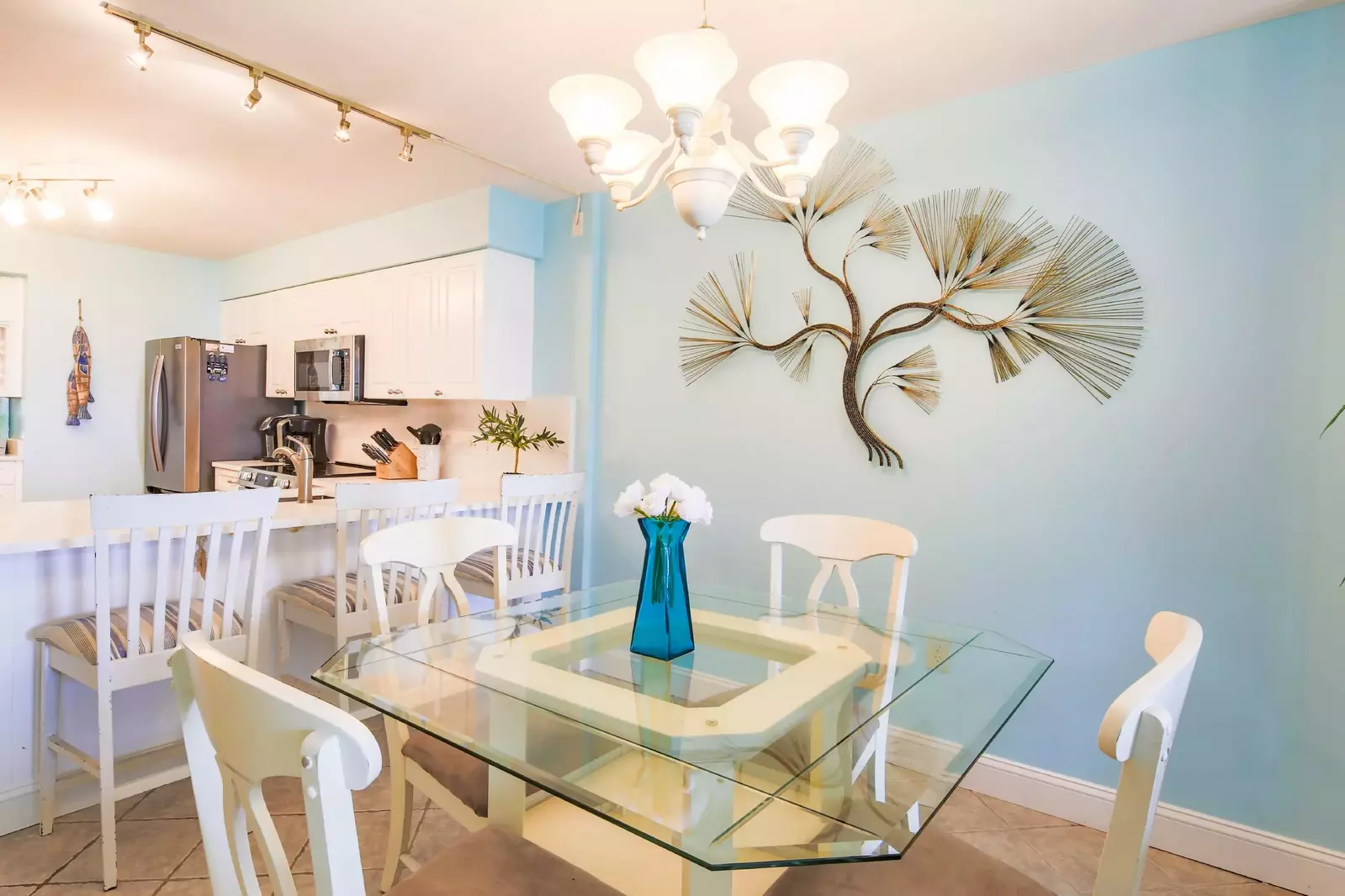 The dining table seats 4.  There are three additional stools at the kitchen counter.