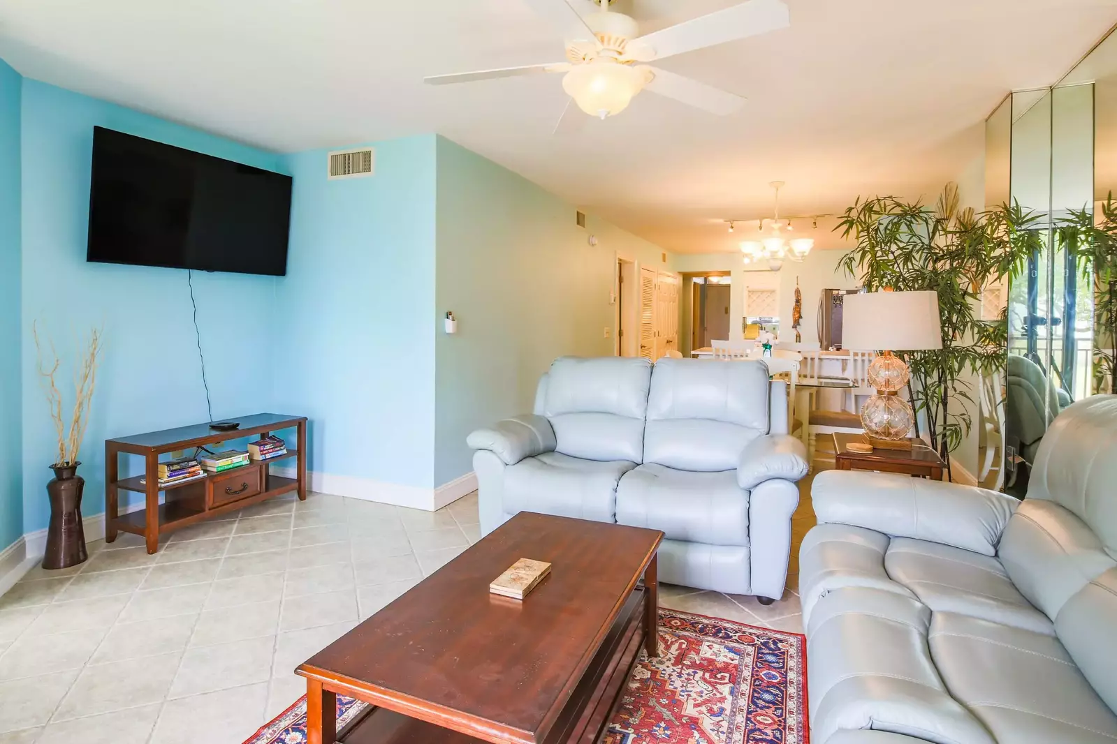 The living room features a sofa, love seat and streaming TV.