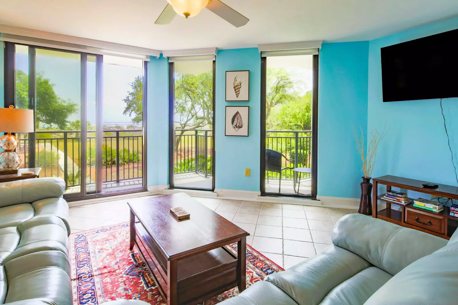 The large living room windows feature ocean views and access to a private balcony.