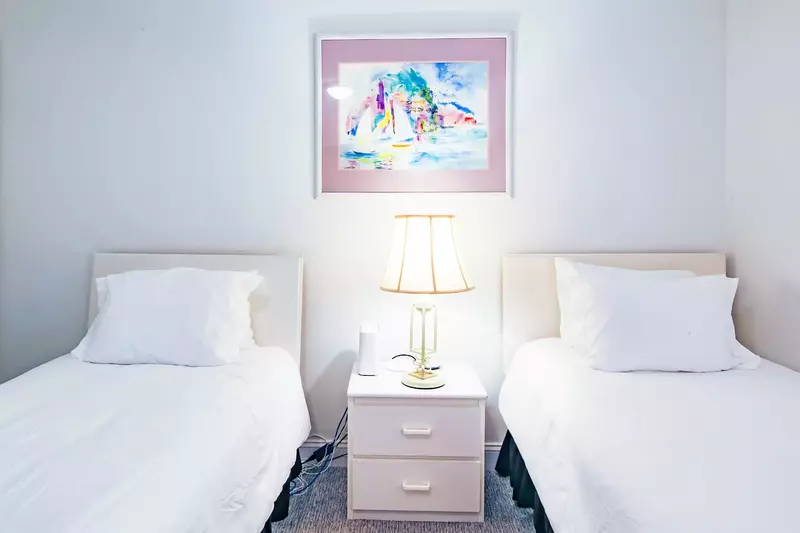 There is also a night stand and reading lamp that separates the two twin beds.