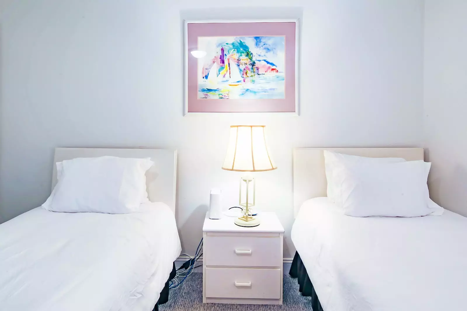 There is also a night stand and reading lamp that separates the two twin beds.