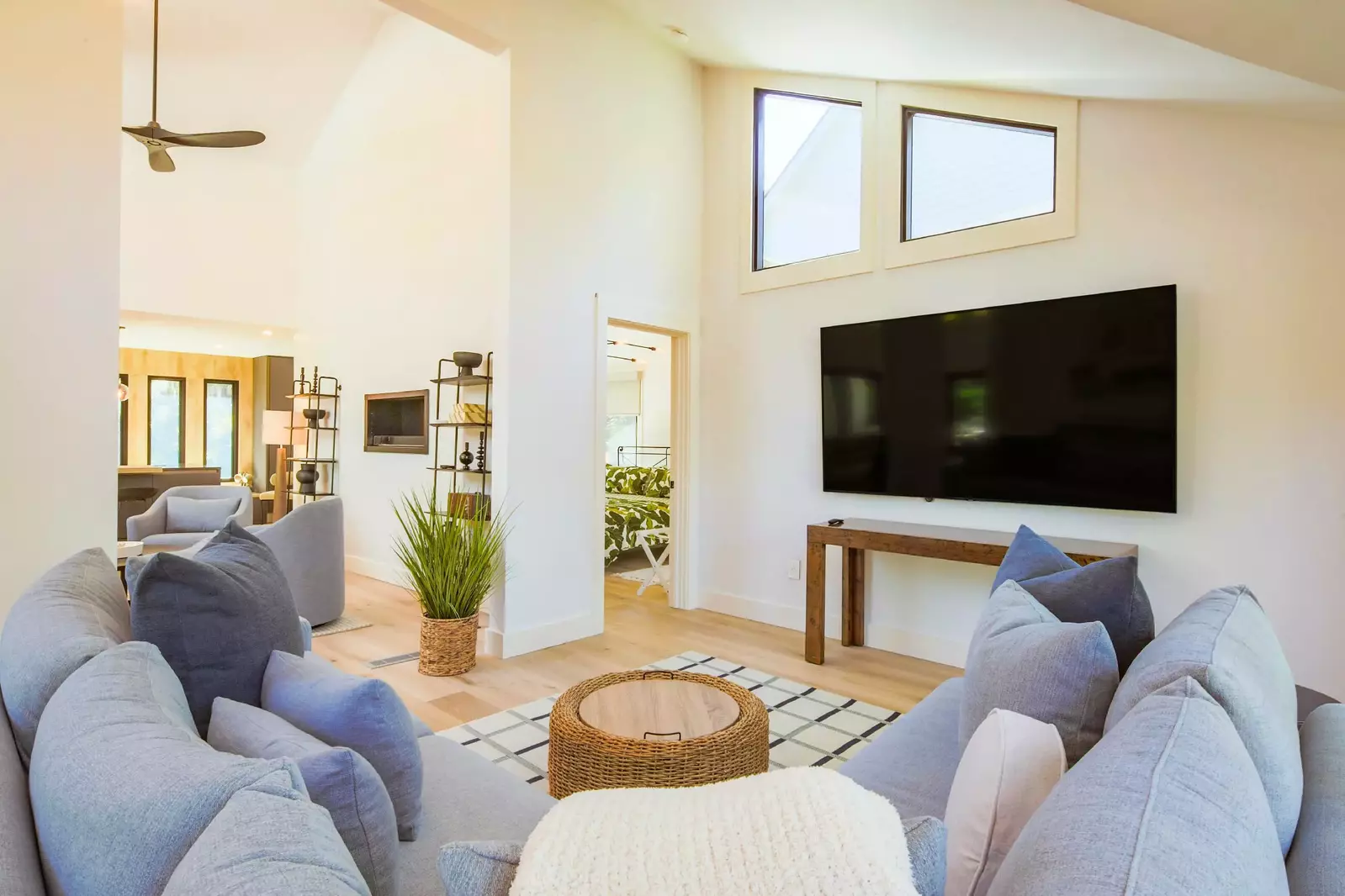 The living room, with its spacious sectional sofa, is located near the back deck.