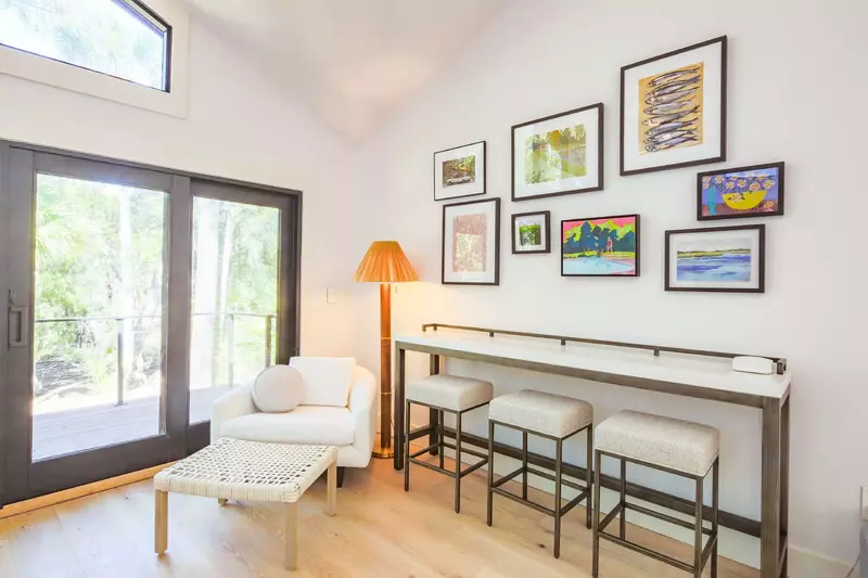 This sitting area and table are located in the living room near the door to the back deck.