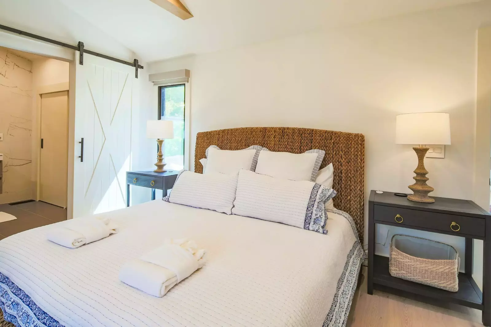 The primary bedroom has night stands and reading lamps.