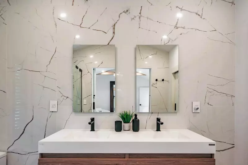 The en suite bathroom features a dual sink vanity.