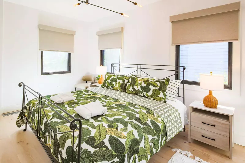 This guest bedroom near the living room features wonderful natural light.