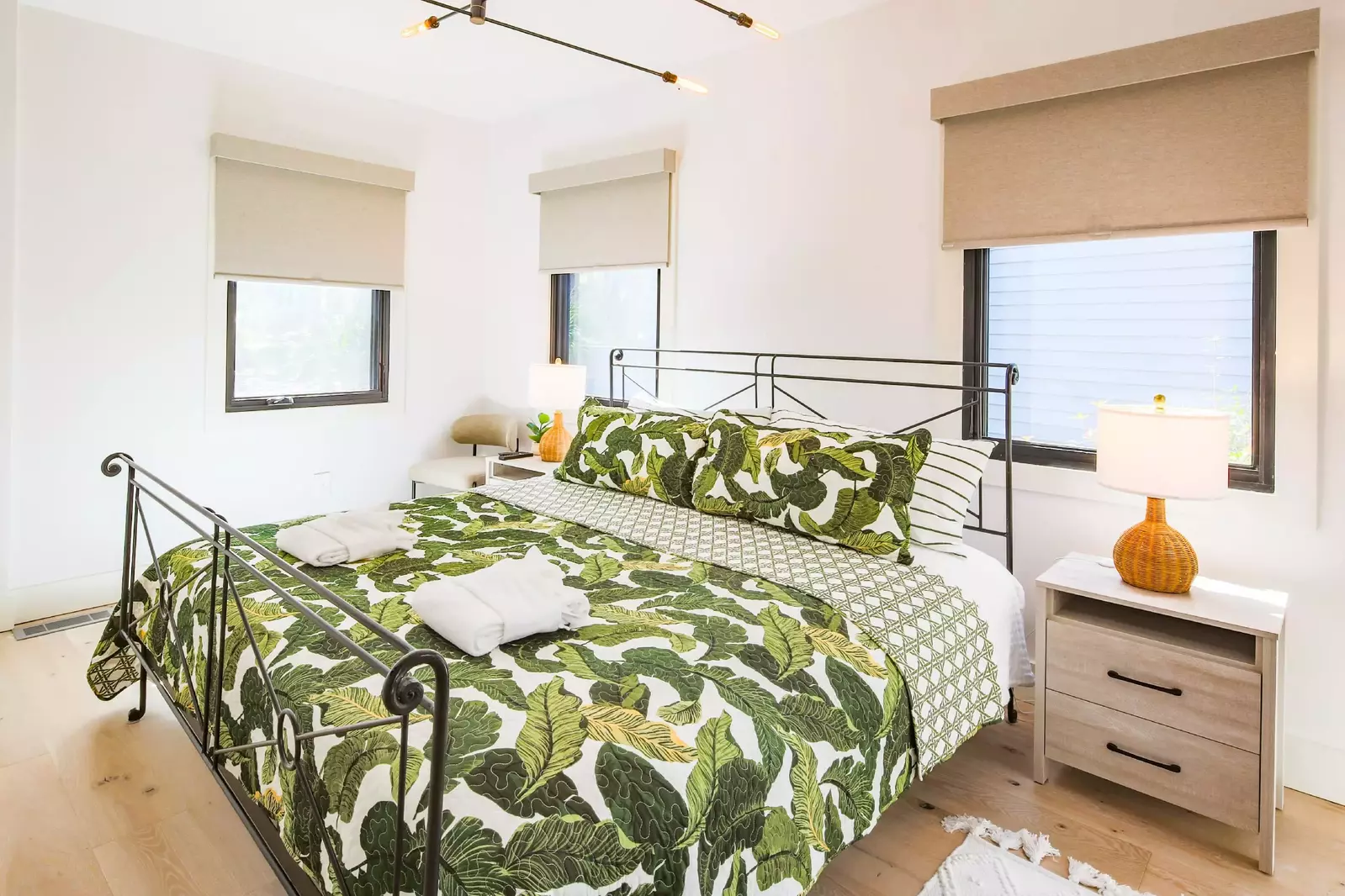 This guest bedroom near the living room features wonderful natural light.