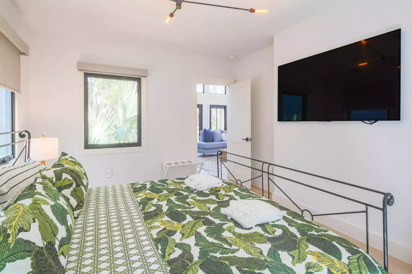 This guest bedroom also features a wall-mounted smart TV.