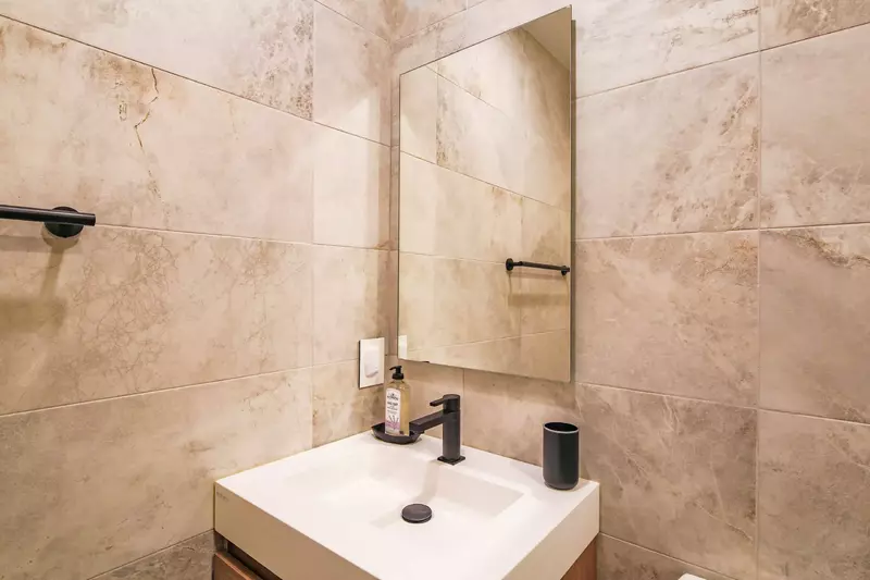 The en suite bathroom features a beautiful vanity.