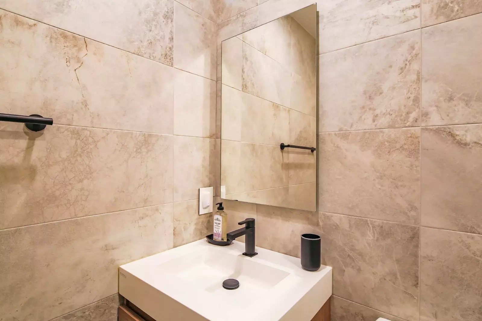 The en suite bathroom features a beautiful vanity.