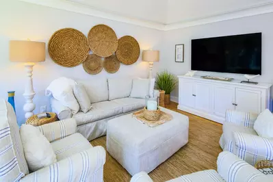 This impeccably designed villa features a spacious seating area with a large screen TV.