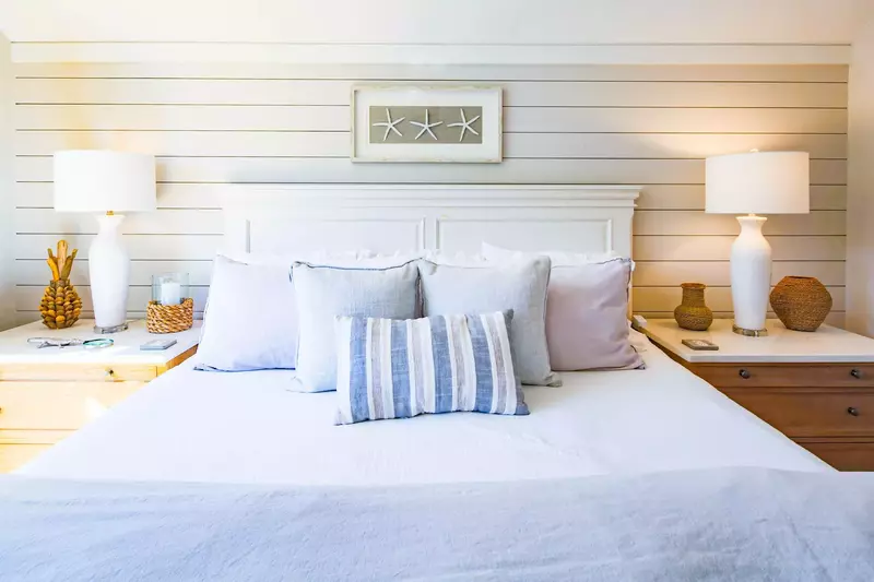 The master suite features a king bed and night stands with reading lamps.