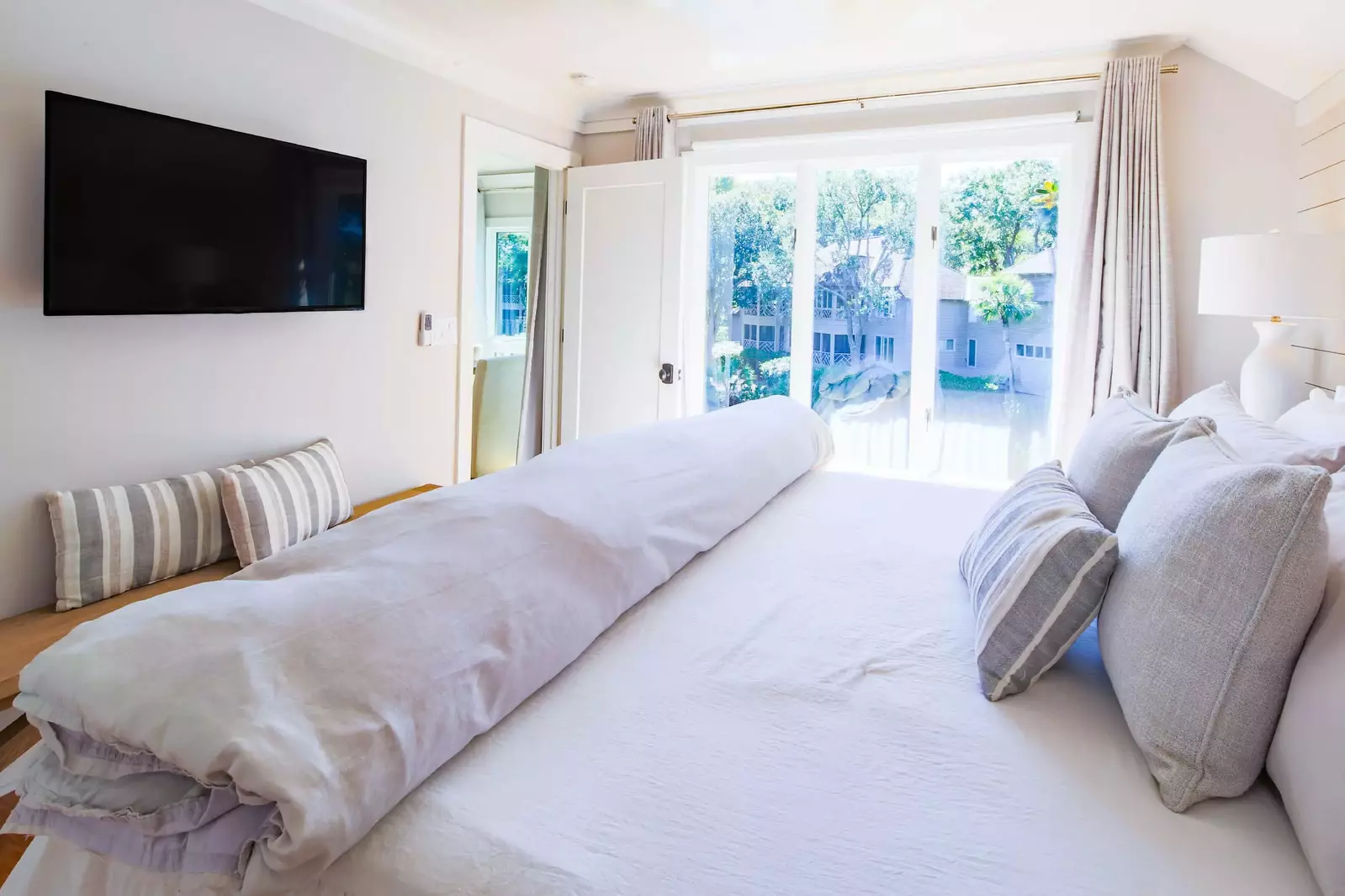 The master suite also has a wall-mounted TV, bench and lagoon views.