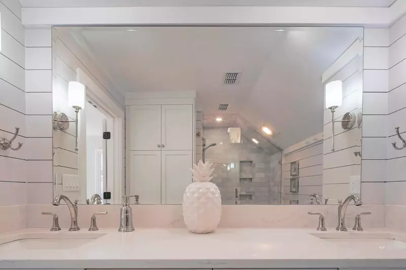 The master en suite bathroom also has shiplap walls and bright lighting.