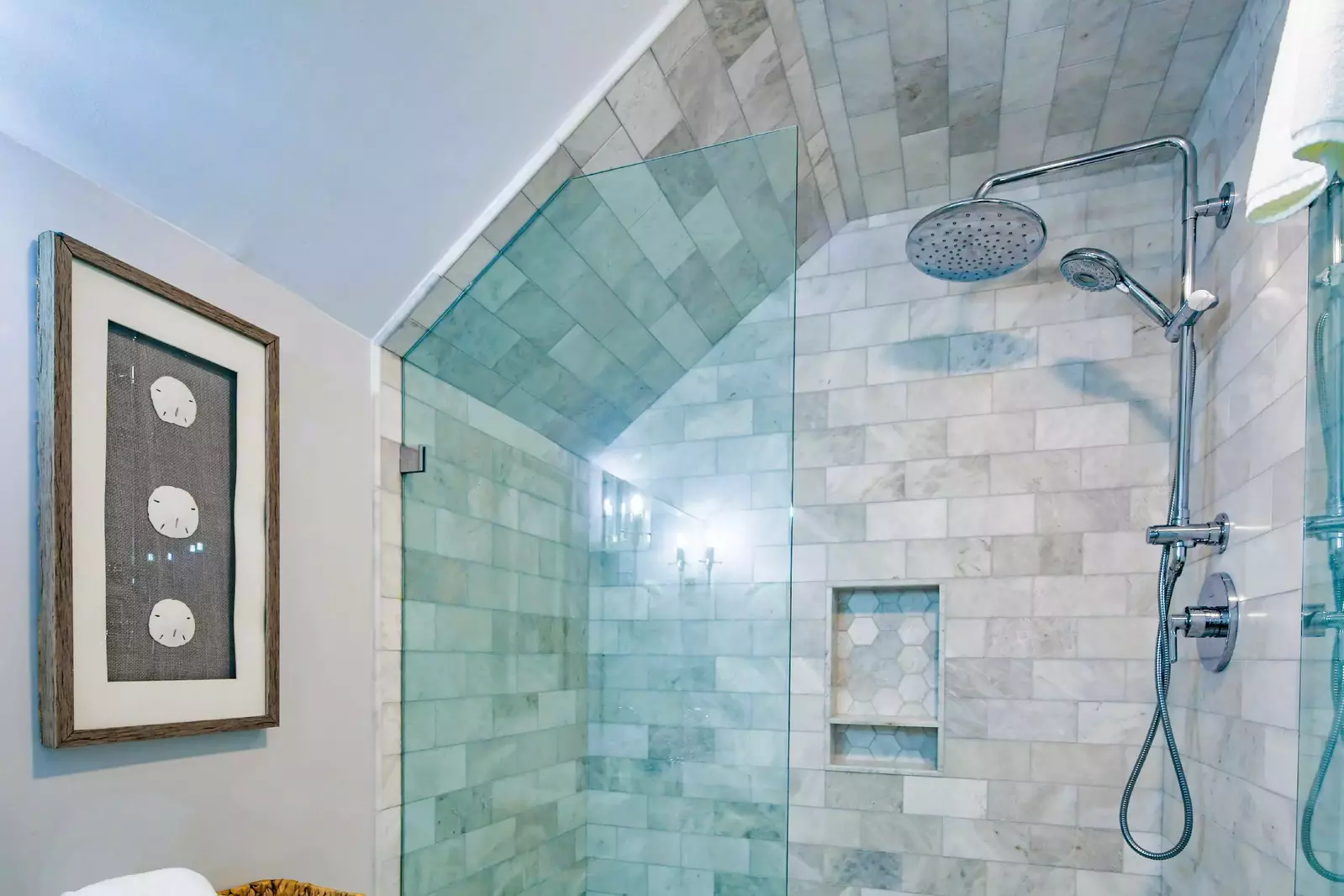 The guest bathroom features a tiled, walk-in shower.