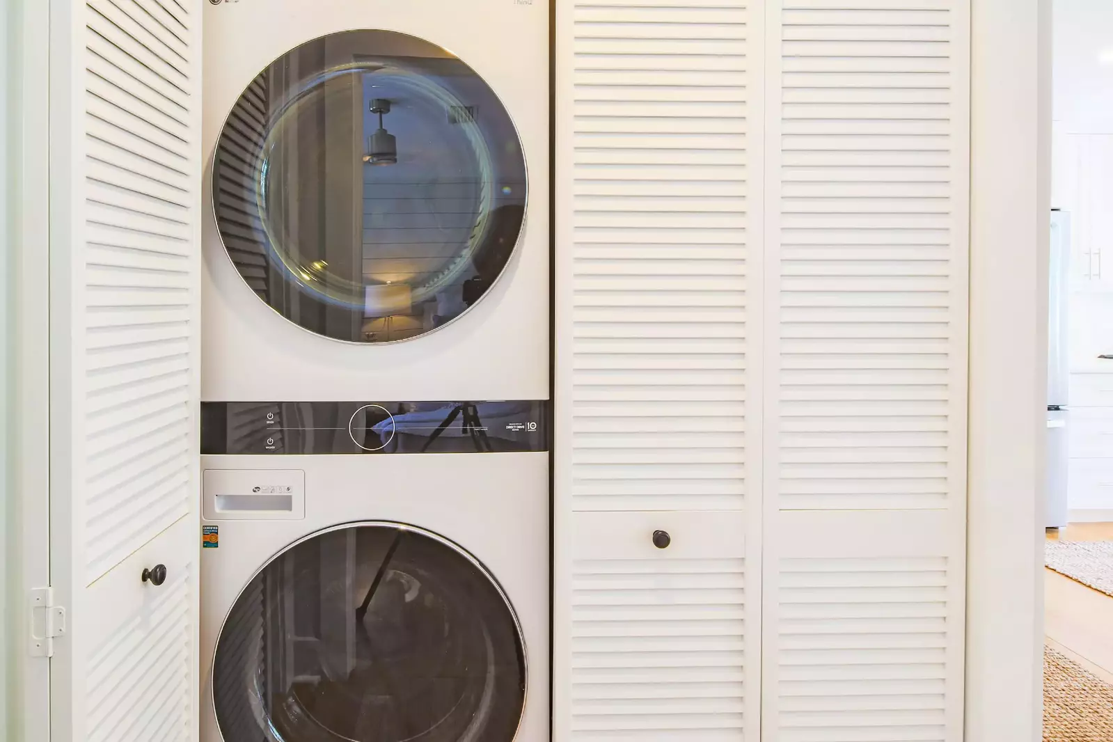 There is a stacked washing machine & dryer in the hallway outside the guest bedroom.