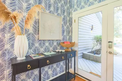 When you enter the front door, you will find this entrway with coastal-themed wallpaper.