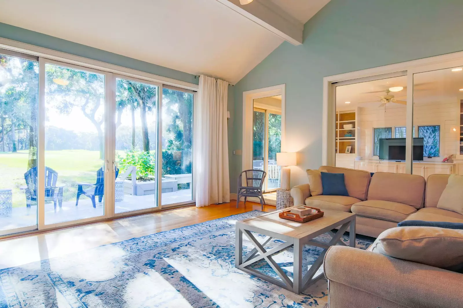 The living room features a spacious seating area, wonderful natural light and golf course views.