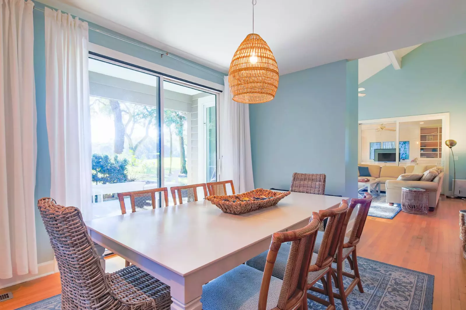 The dining table, which seats 8, is located in between the living room and kitchen.