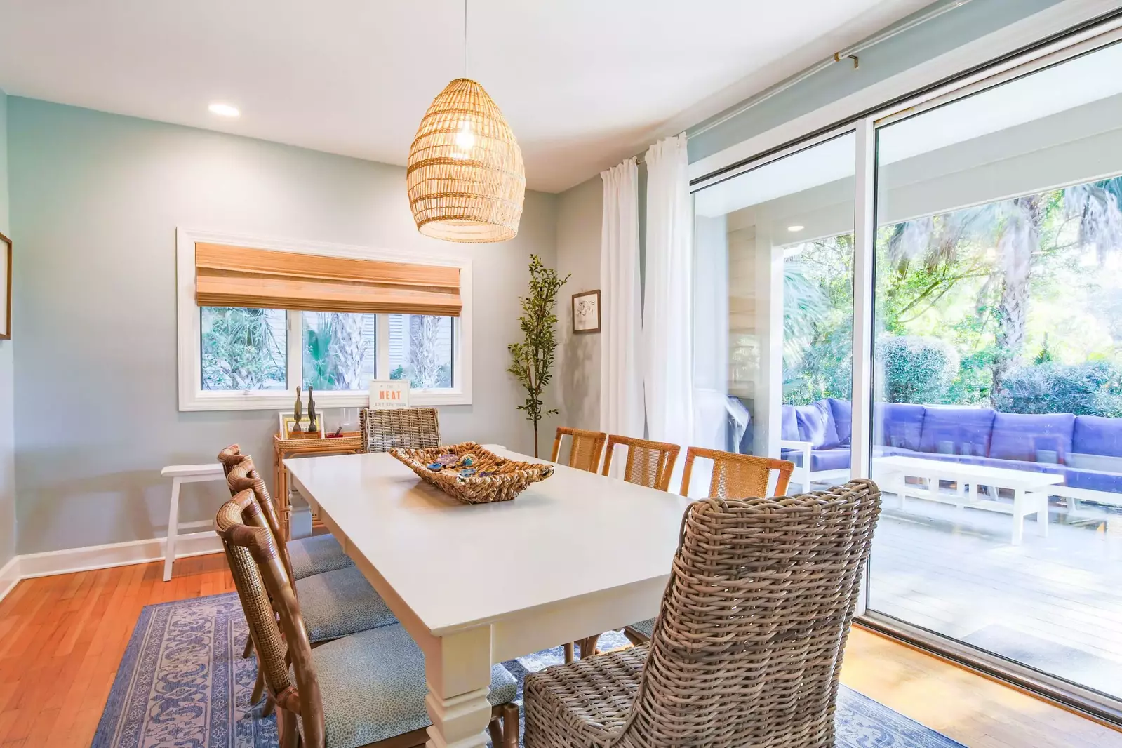 Open the sliding glass door to access the back deck with an outdoor sectional sofa.