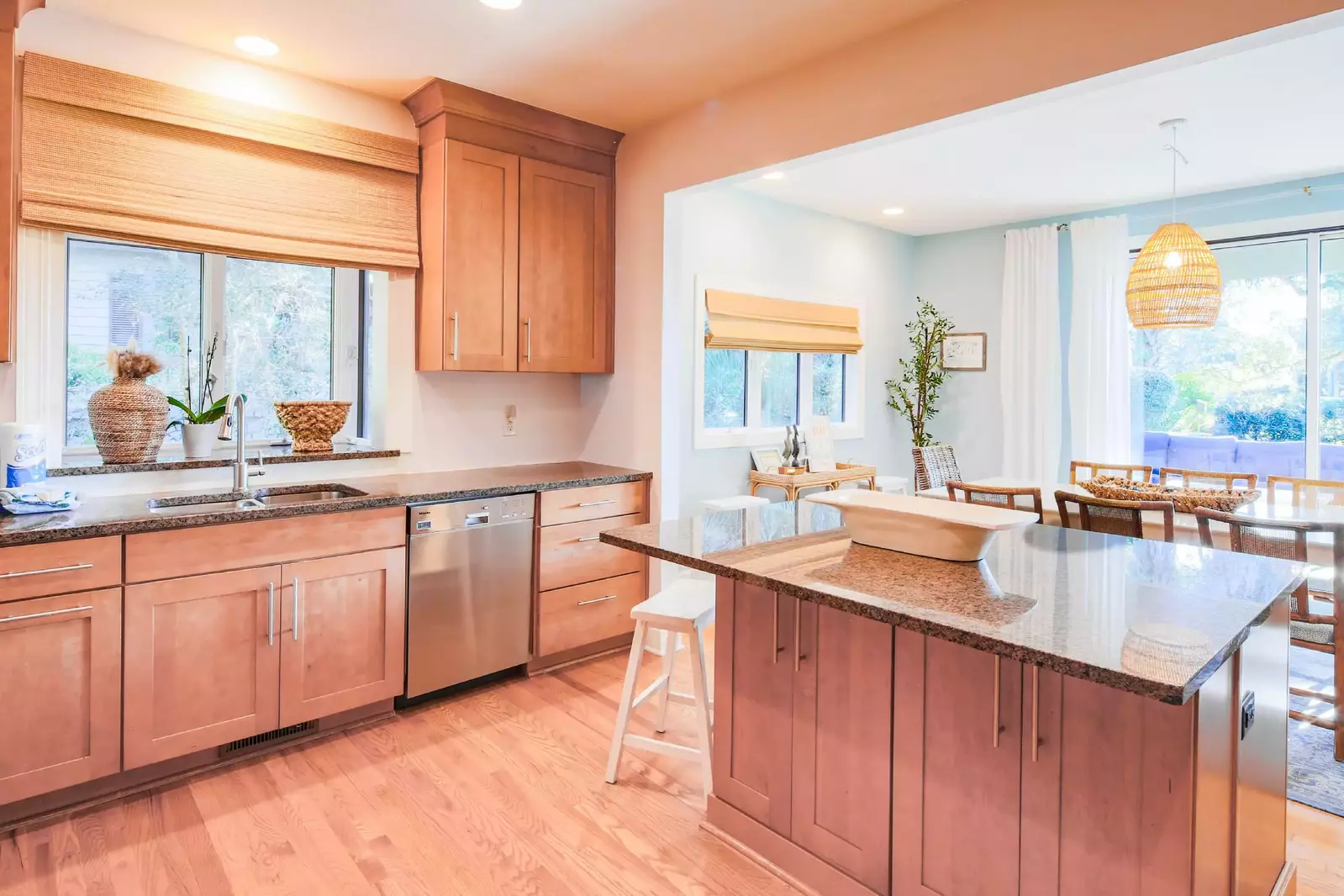 The kitchen features a central island, shaker-style cabinets and quartz countertops.