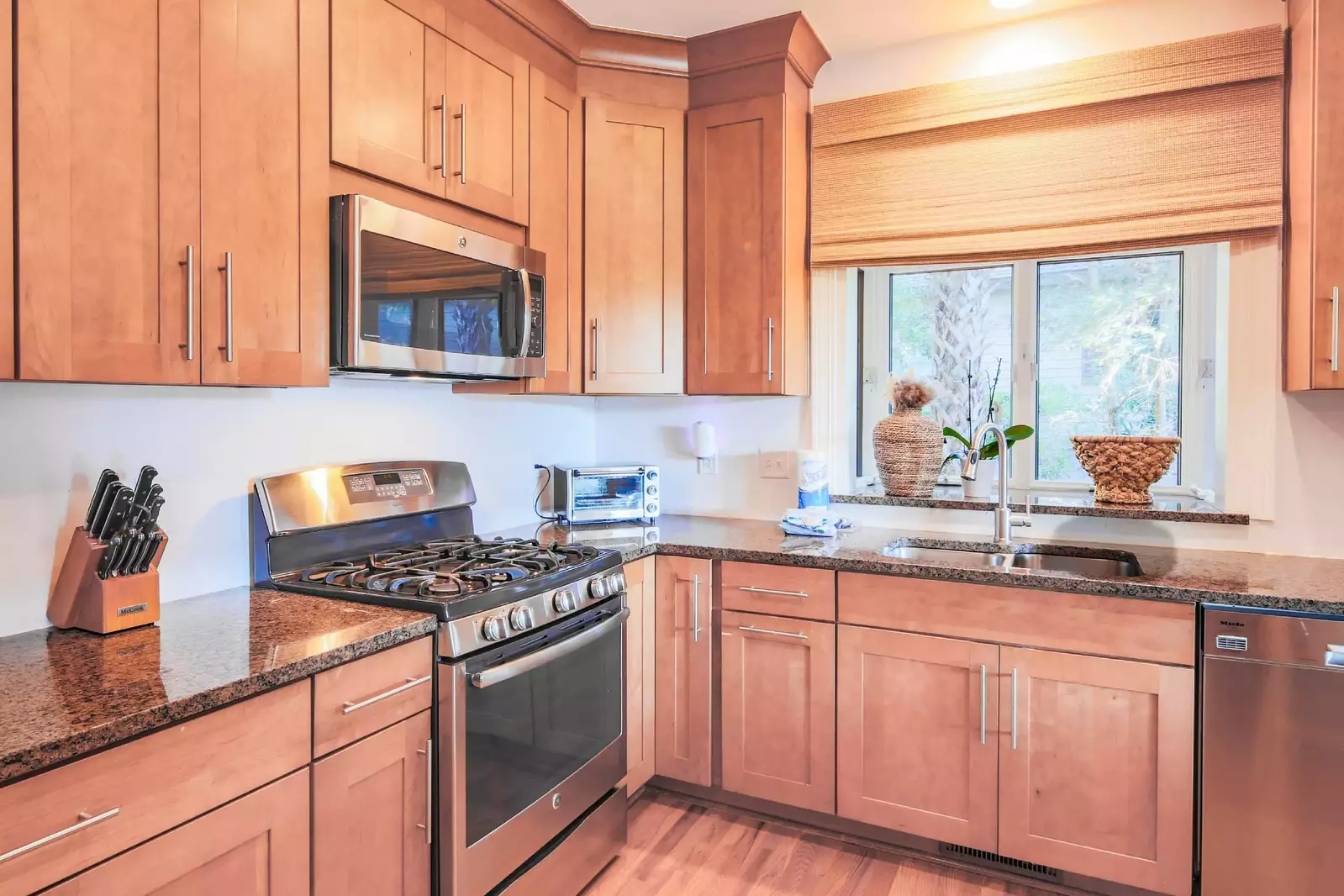 The kitchen also features stainless steel appliances, including a gas range, dishwasher and microwave.