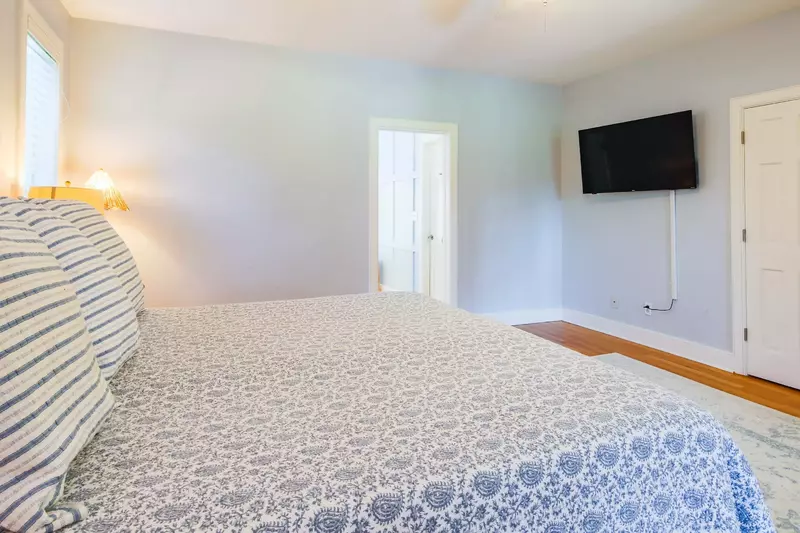 The master suite also features a wall-mounted TV, closet and en suite bathroom.