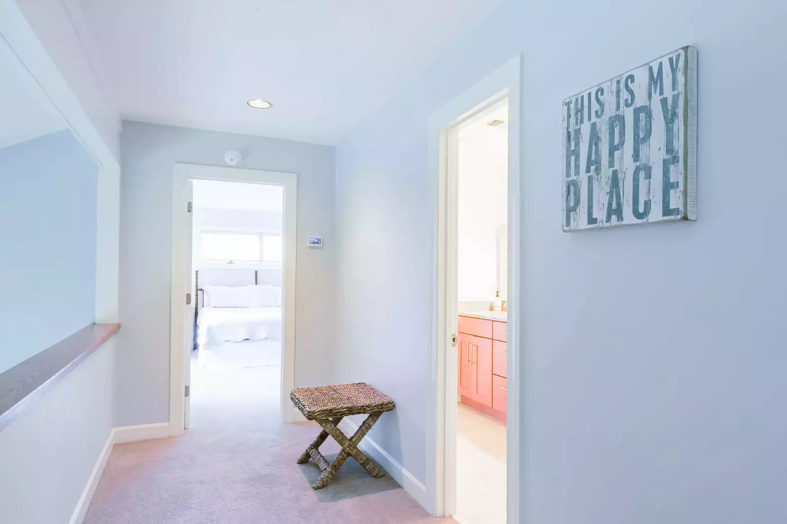 This hallway leads to the en suite bedrooms on the top floor of the home.