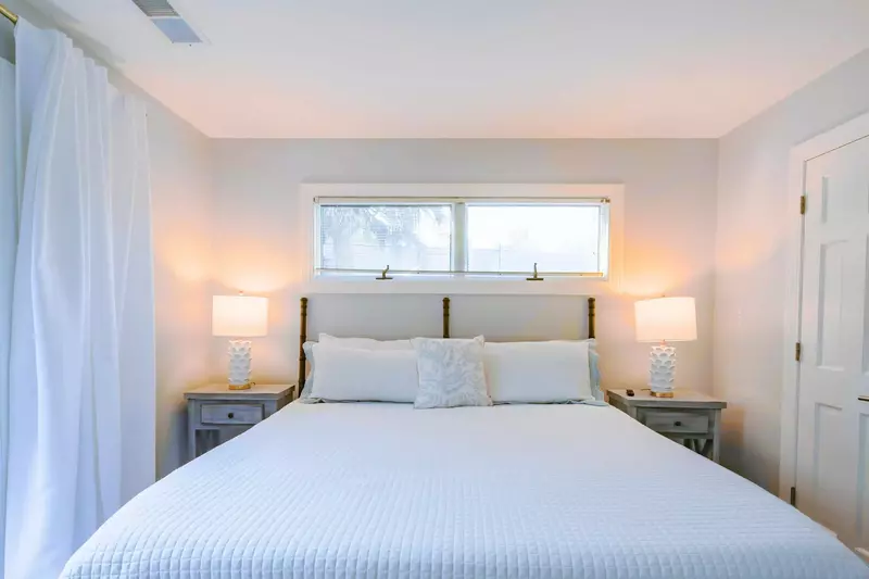 The king suite features a king bed and night stands with reading lamps.