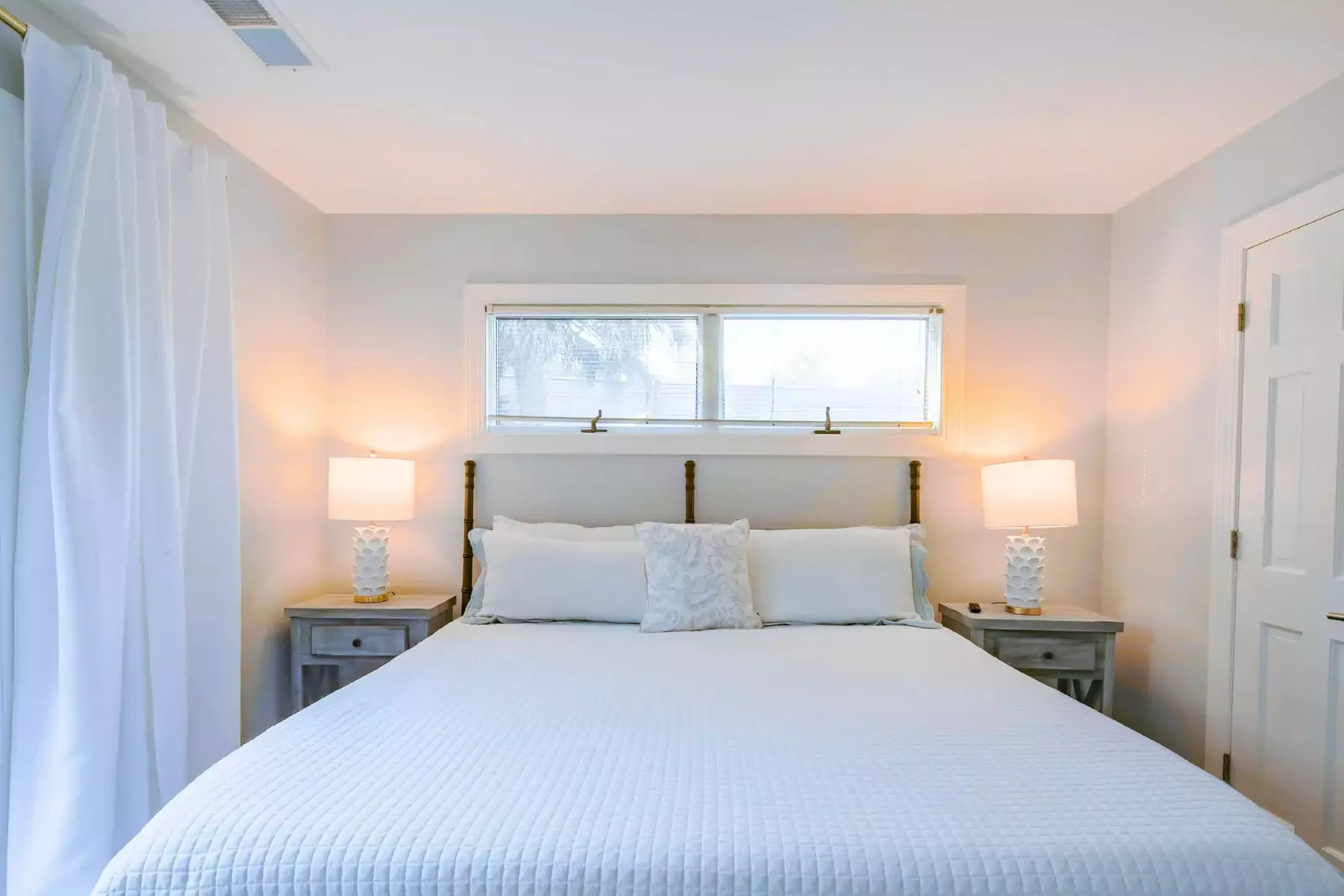 The king suite features a king bed and night stands with reading lamps.