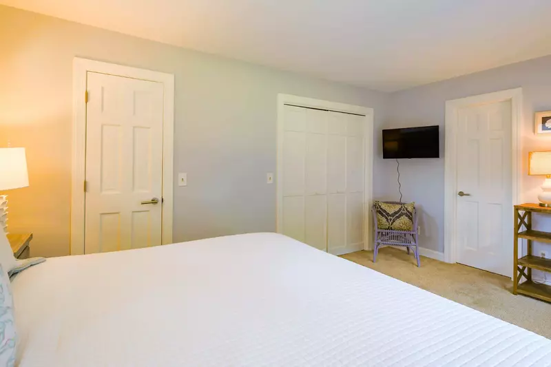 The king suite has a wall-mounted smart TV and an en suite bathroom.