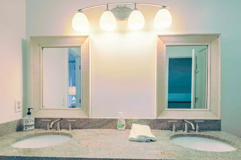 The en suite bathroom features a dual sink vanity.