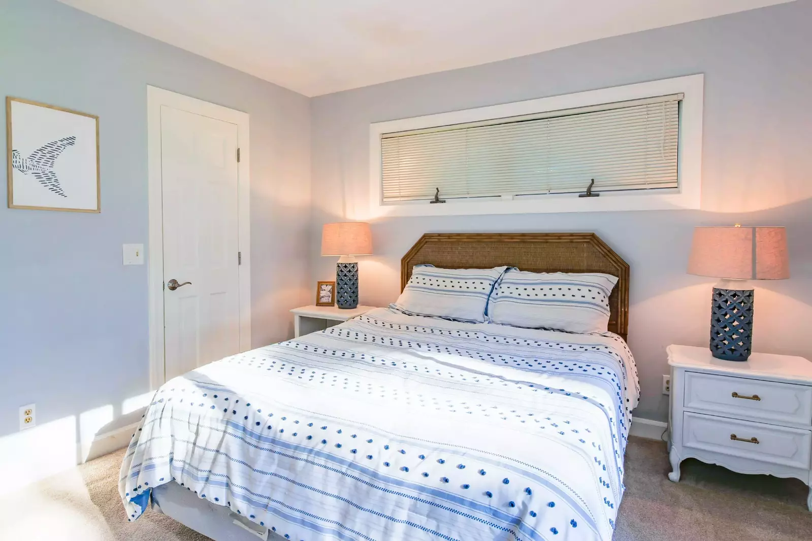 The guest suite features a queen bed and night stands with reading lamps.