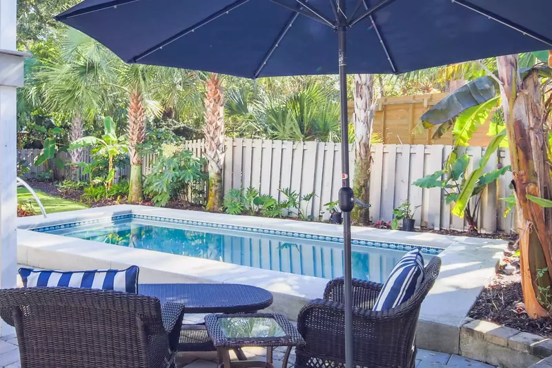 Waterway Oasis features an incredible backyard with private pool and tropical landscaping.