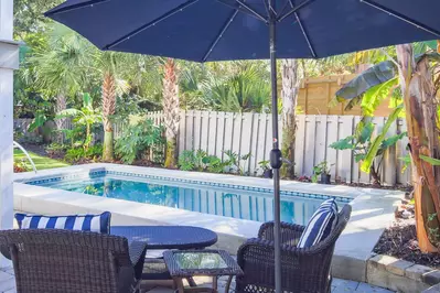 Waterway Oasis features an incredible backyard with private pool and tropical landscaping.