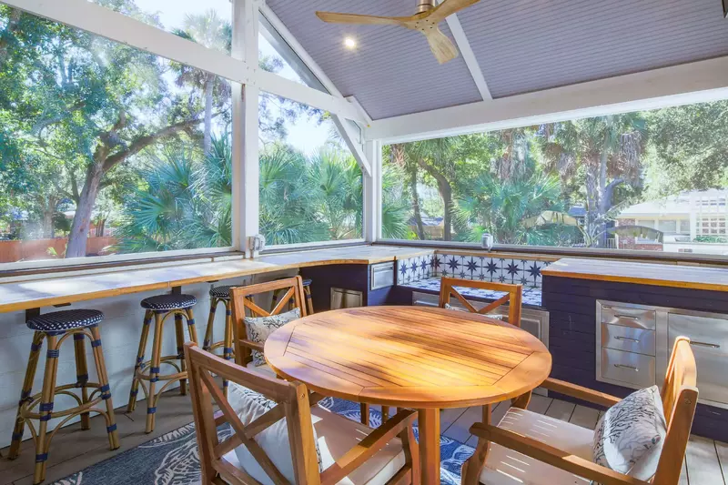 This terrific screened porch is located off the kitchen and near the stairs to the backyard & pool.