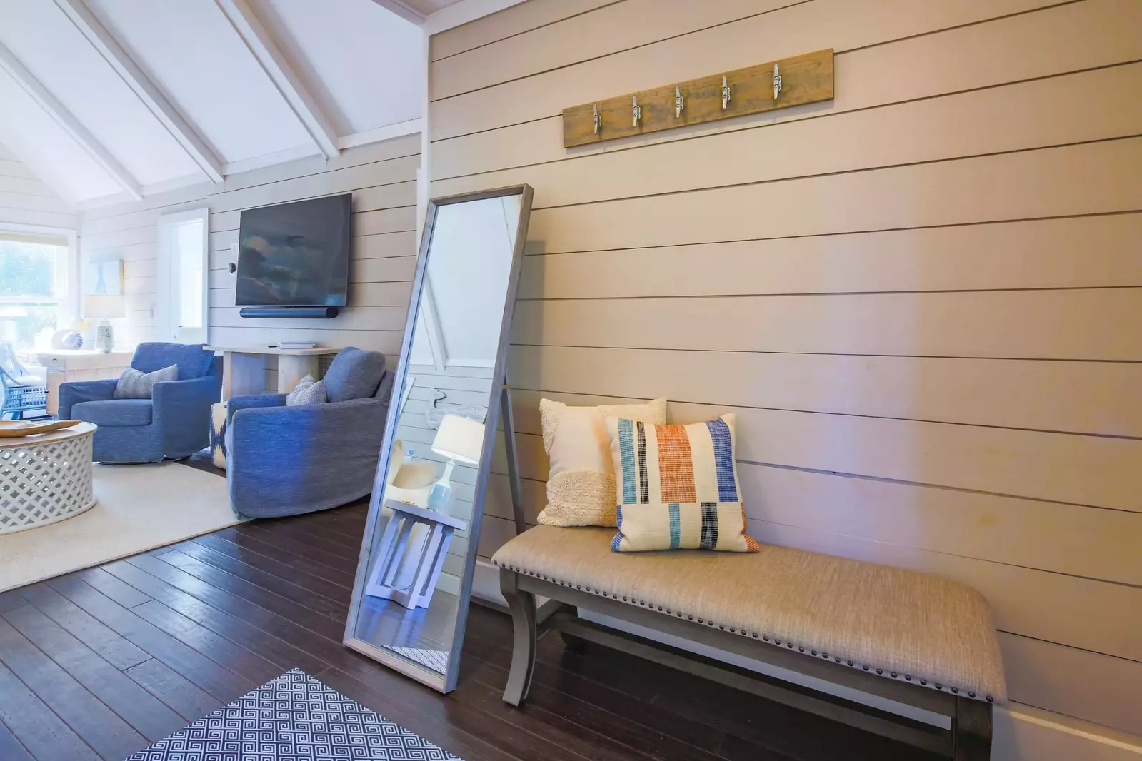 There is also a bench and full-length mirror in the home's entryway.