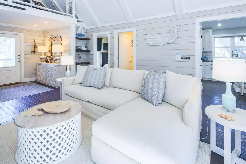 The entryway leads to a central living room with vaulted ceilings.  (Please note loft is not available for guest use.)