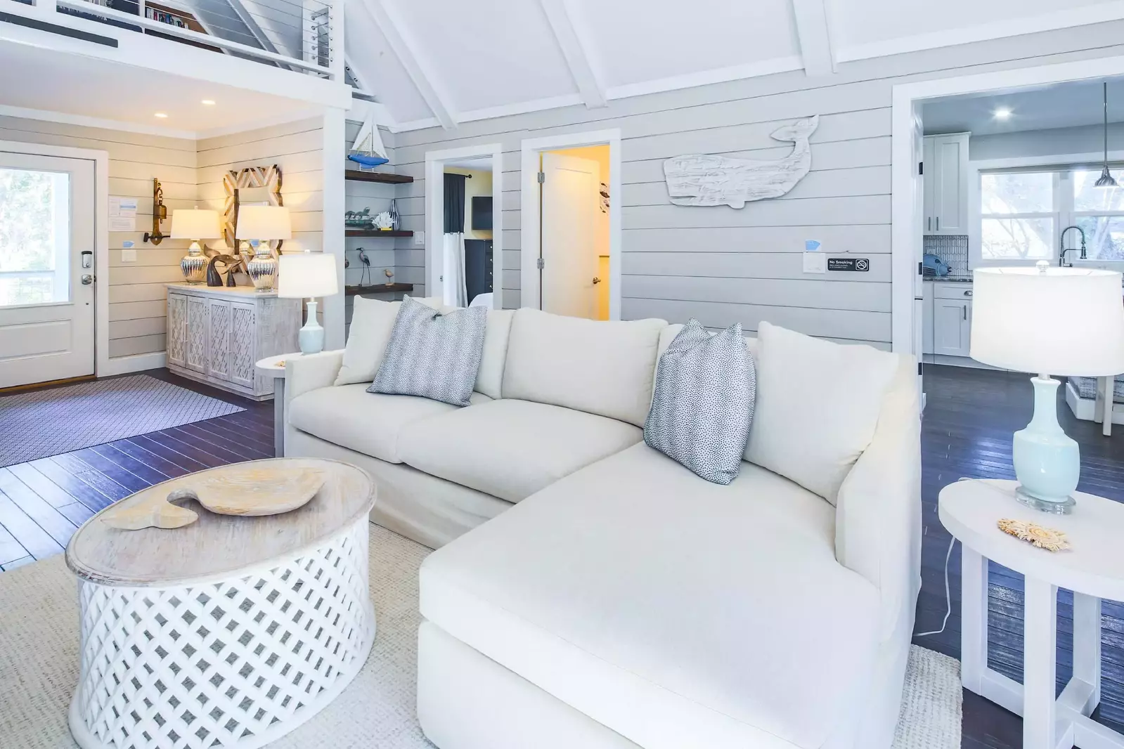 The entryway leads to a central living room with vaulted ceilings.  (Please note loft is not available for guest use.)