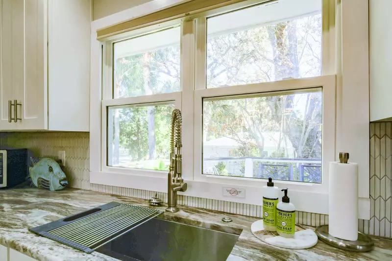 The windows near the kitchen sink look out onto the home's deck.