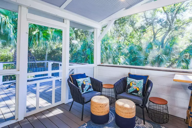 Step out of the doors in the kitchen onto the screened porch.