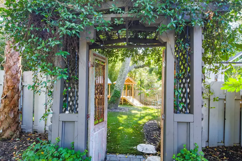 We are swooning over the gates within this backyard tropical oasis.