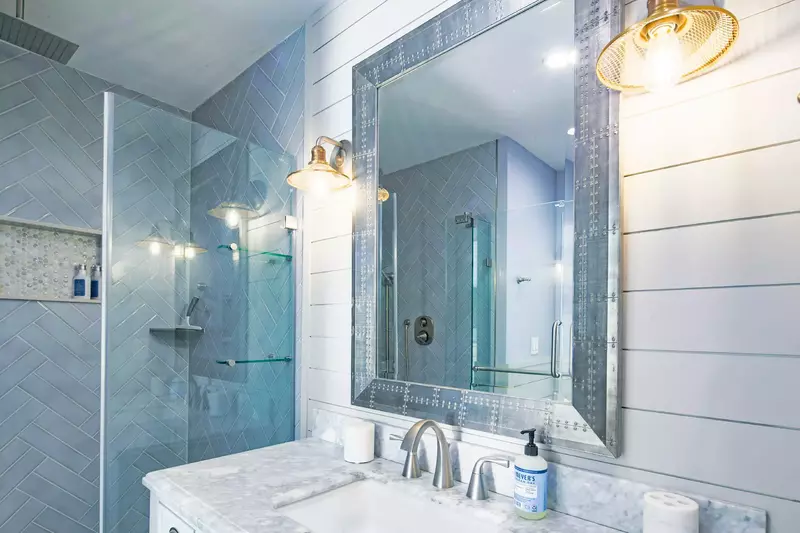 The primary en suite bathroom features ship lap walls and a beautiful vanity.