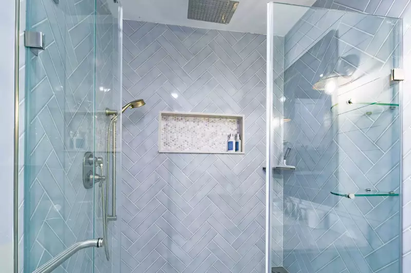 The primary en suite bathroom also has a tiled, walk-in shower with two shower heads.